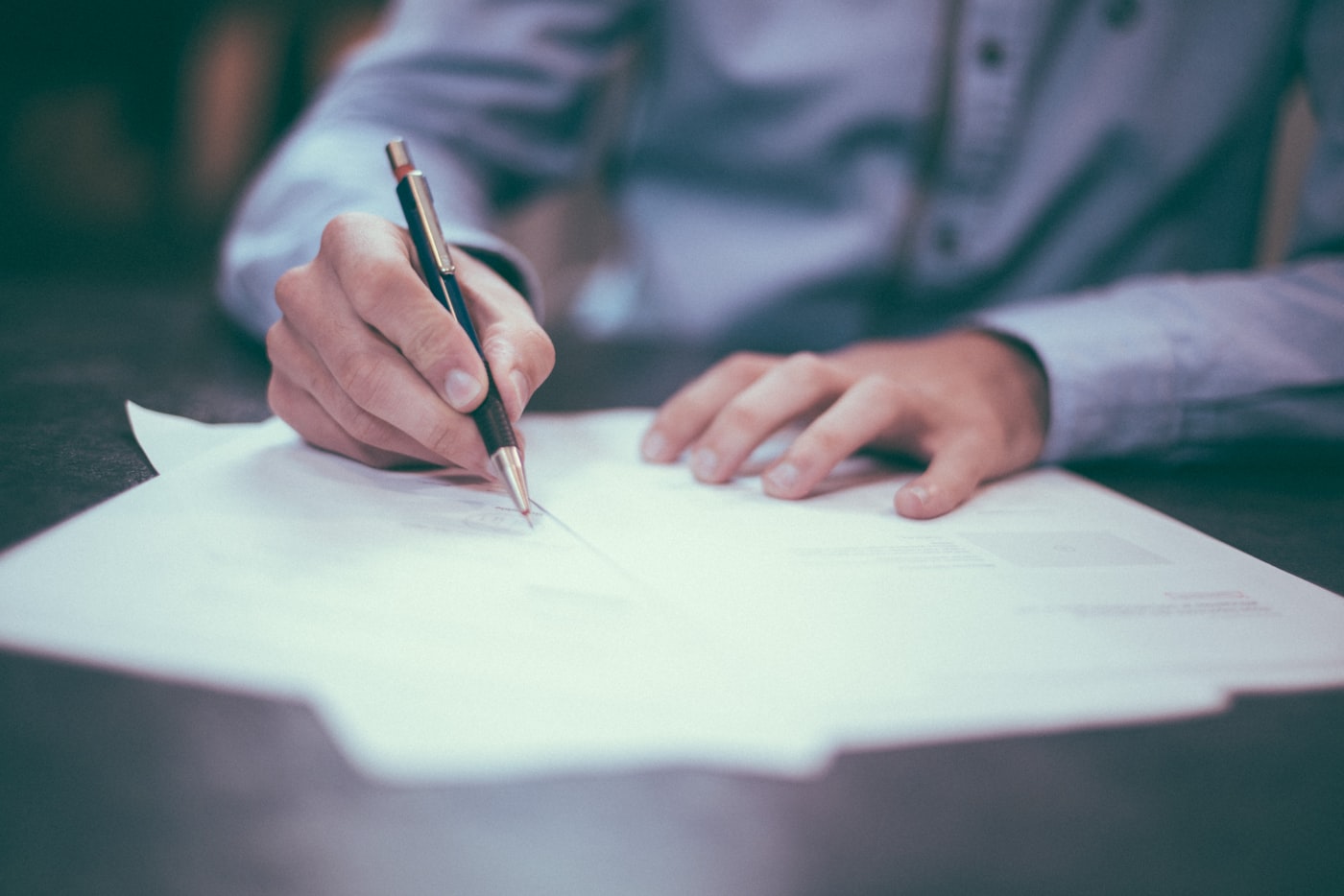 Signing an official document with a pen